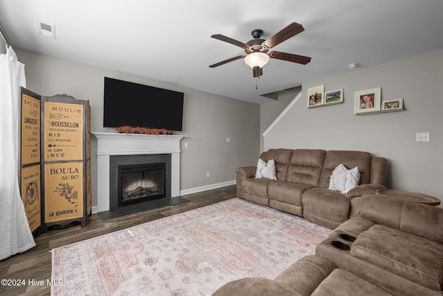 living room with dark hardwood / wood-style floors and ceiling fan