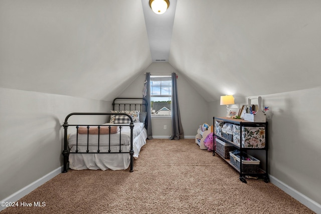 bedroom featuring lofted ceiling and light carpet