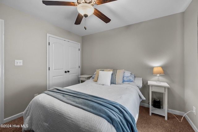 carpeted bedroom featuring ceiling fan and a closet