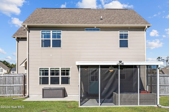 back of property featuring a lawn and a patio