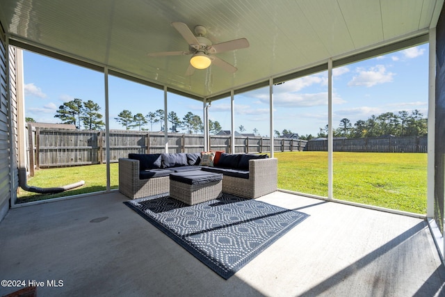 sunroom / solarium featuring ceiling fan