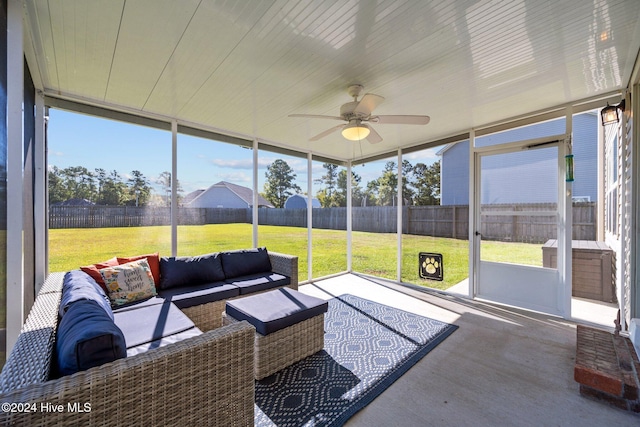 sunroom / solarium featuring ceiling fan