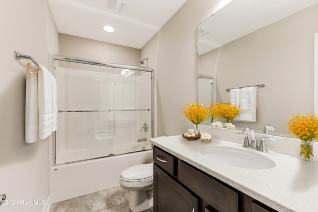 full bathroom featuring vanity, enclosed tub / shower combo, and toilet