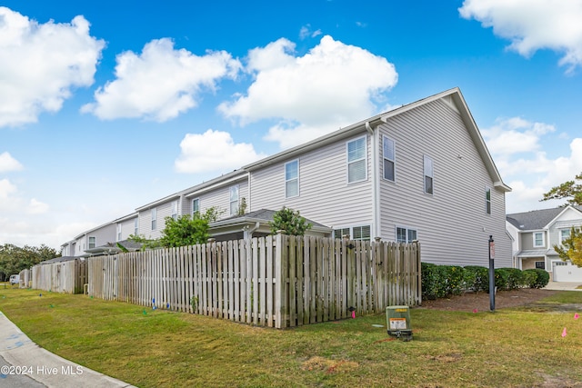 view of side of home with a lawn