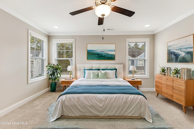 bedroom featuring light carpet, crown molding, and ceiling fan