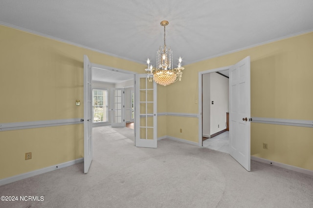 unfurnished dining area featuring french doors, light carpet, ornamental molding, and a chandelier