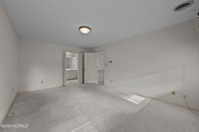 empty room with light carpet and ornamental molding