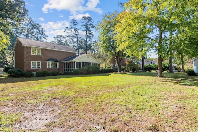 view of yard with a sunroom