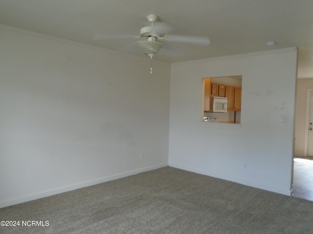 unfurnished room featuring light carpet, ornamental molding, and ceiling fan