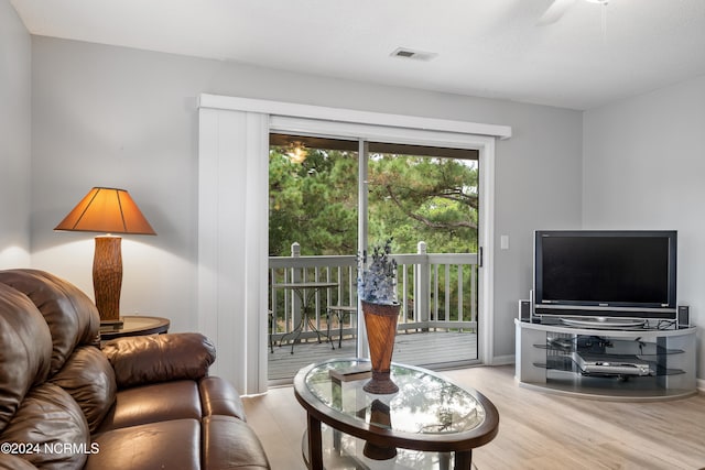 living room with light wood-type flooring and ceiling fan