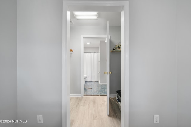 hallway with light hardwood / wood-style flooring