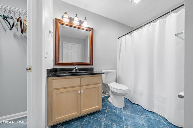 bathroom featuring vanity, toilet, tile patterned floors, and a shower with curtain