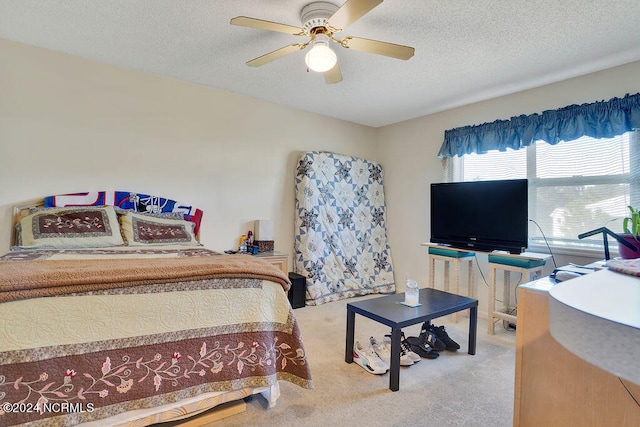 carpeted bedroom with a textured ceiling and ceiling fan