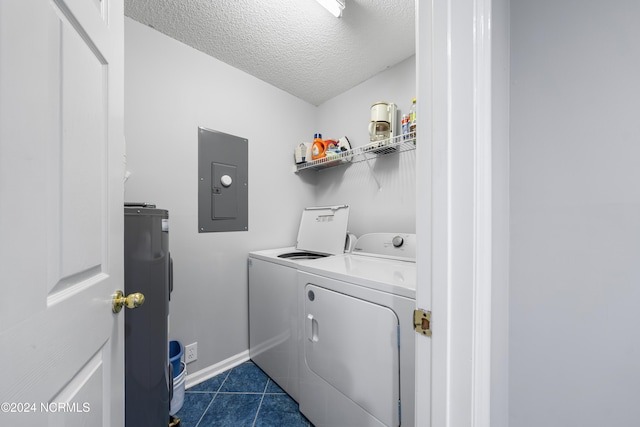 laundry area featuring dark tile patterned flooring, washer and dryer, a textured ceiling, electric water heater, and electric panel