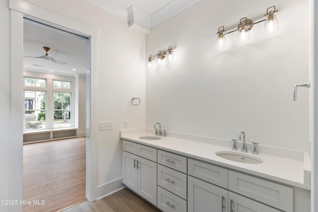 5312 Hanahan Dr, Wilmington, NC 28403 - bathroom featuring ceiling fan, double vanity, wood finished floors, and crown molding