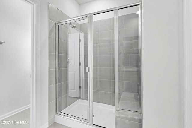 bathroom featuring a shower with door
