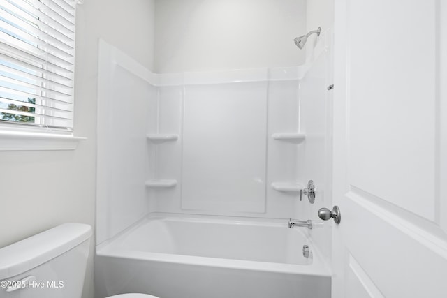 bathroom with shower / tub combination and toilet