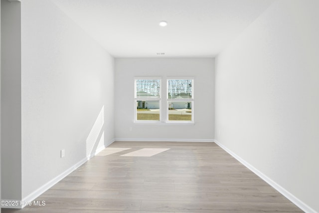 spare room with light wood-type flooring