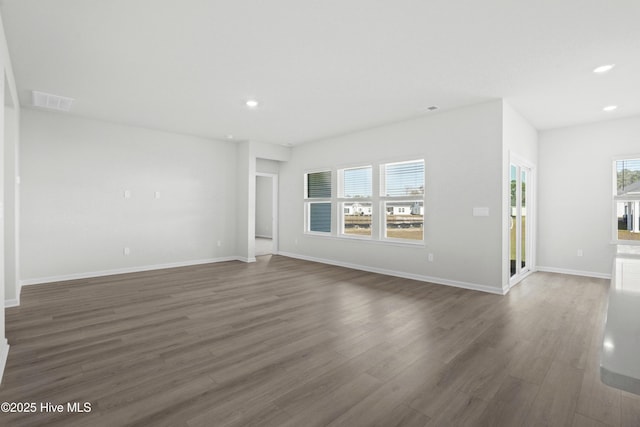 unfurnished living room featuring dark wood-type flooring
