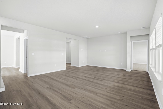spare room with dark wood-type flooring