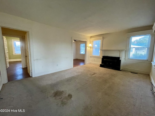 unfurnished living room with hardwood / wood-style floors and a healthy amount of sunlight