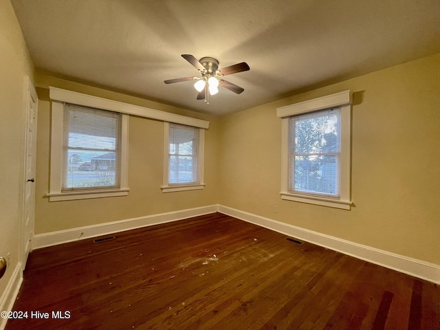 unfurnished room with ceiling fan and dark hardwood / wood-style floors