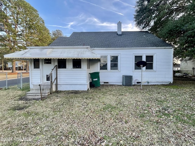 rear view of house featuring central air condition unit