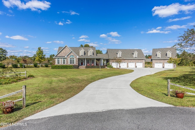 cape cod house with a garage, a front yard, and a porch