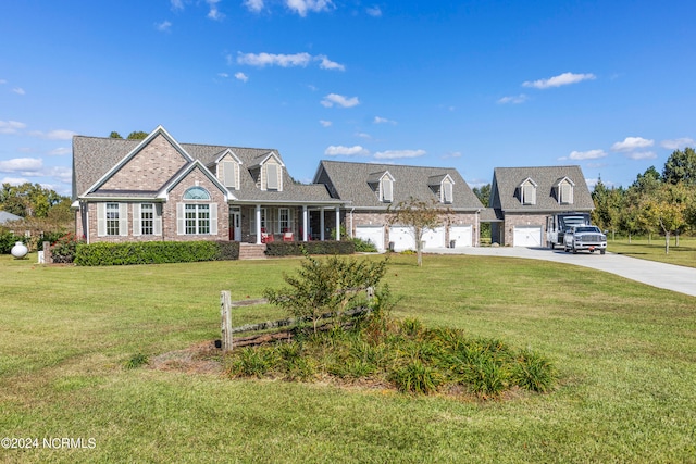 cape cod-style house featuring a front lawn and a garage