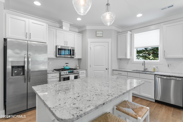 kitchen with sink, appliances with stainless steel finishes, and white cabinets