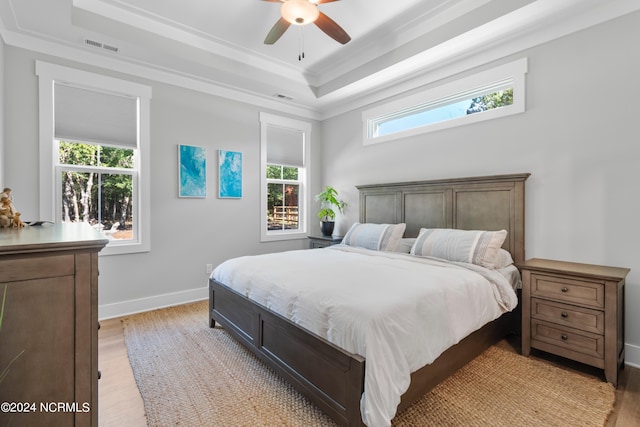 bedroom with light hardwood / wood-style flooring, multiple windows, and ceiling fan