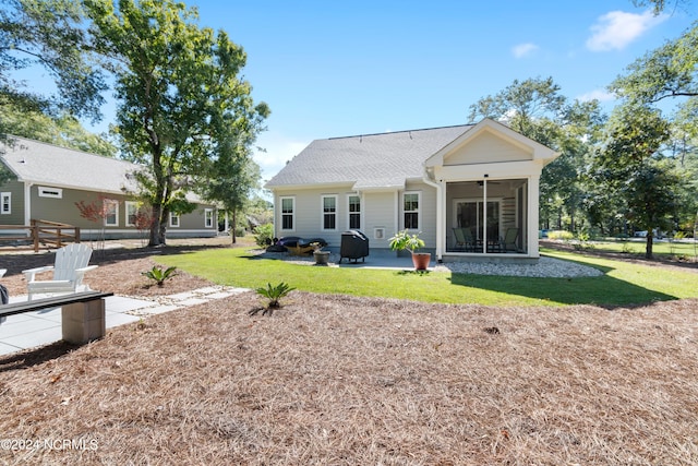 back of house featuring a patio area, a yard, a sunroom, and ceiling fan