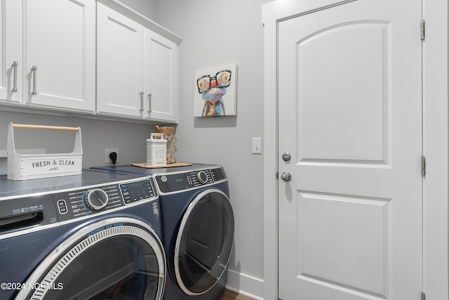 clothes washing area featuring cabinets and washing machine and clothes dryer