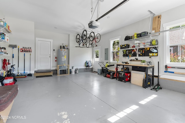 garage with a garage door opener, electric panel, water heater, and a workshop area