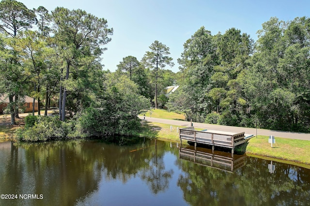 view of dock featuring a yard and a water view