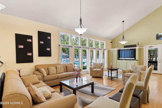 living room featuring french doors, high vaulted ceiling, and light wood-type flooring