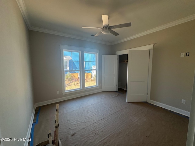 unfurnished bedroom featuring ceiling fan, ornamental molding, carpet flooring, and baseboards