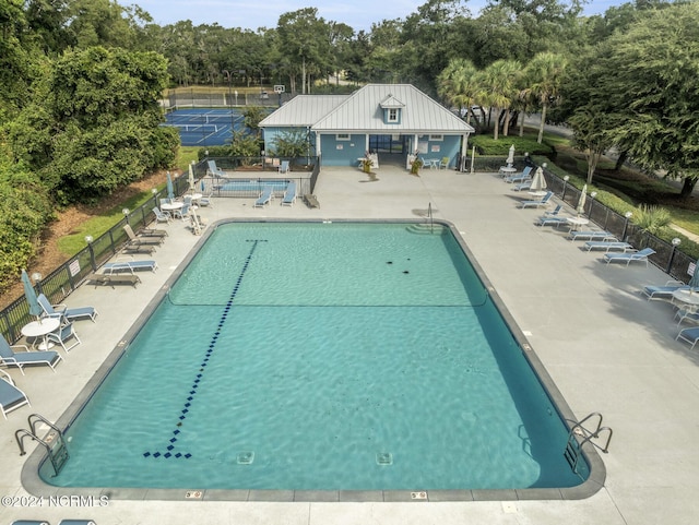 pool featuring fence and a patio