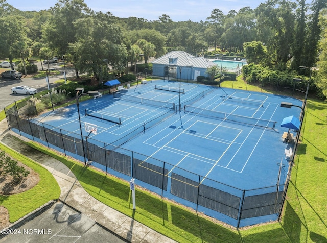 view of tennis court featuring fence