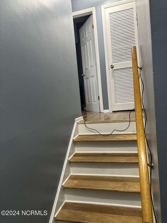 stairway featuring hardwood / wood-style floors