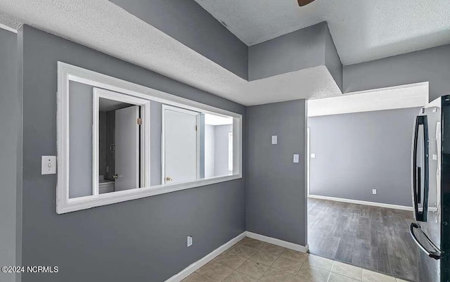 interior space with light hardwood / wood-style floors and a textured ceiling