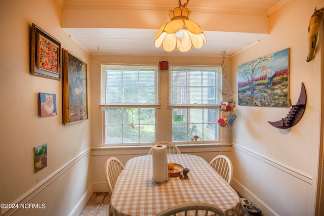 dining room with crown molding and wood-type flooring