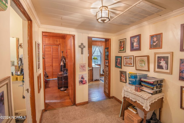 corridor with crown molding and light wood-type flooring