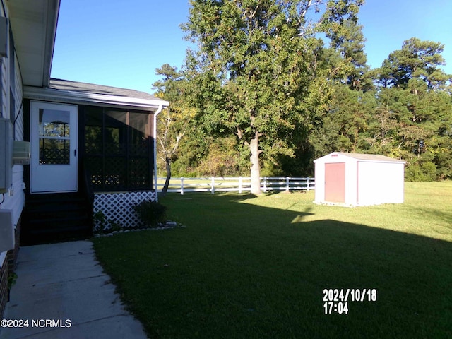 view of yard featuring a sunroom and a shed