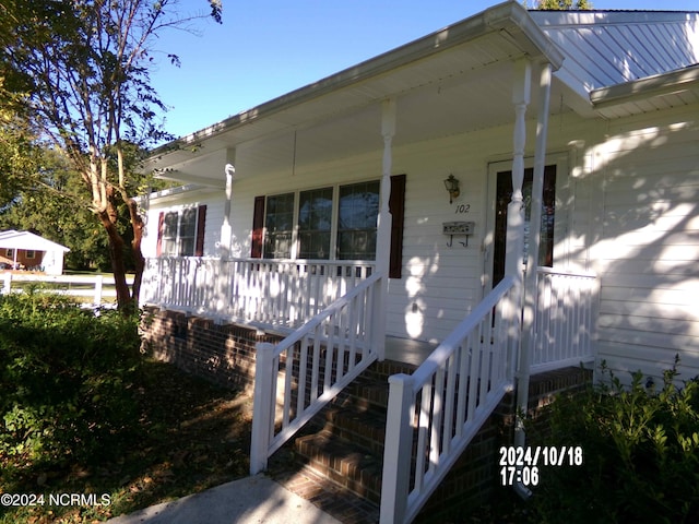 doorway to property with a porch