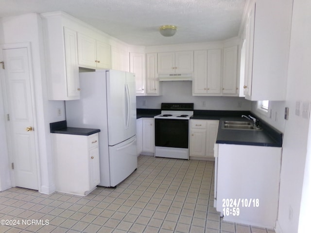 kitchen with white appliances, sink, a textured ceiling, plenty of natural light, and white cabinets