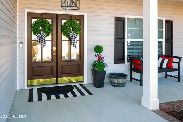 doorway to property with french doors and a porch