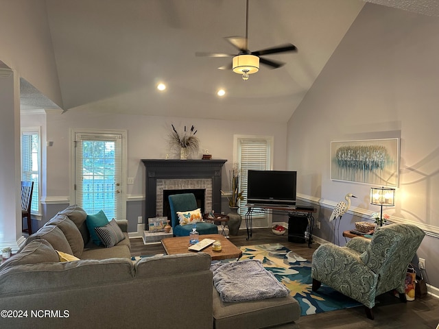 living room featuring hardwood / wood-style flooring, a fireplace, high vaulted ceiling, and ceiling fan