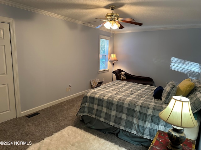 carpeted bedroom with ceiling fan, crown molding, and a textured ceiling