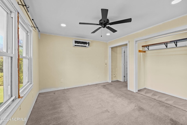 unfurnished bedroom featuring an AC wall unit, light carpet, ceiling fan, and crown molding